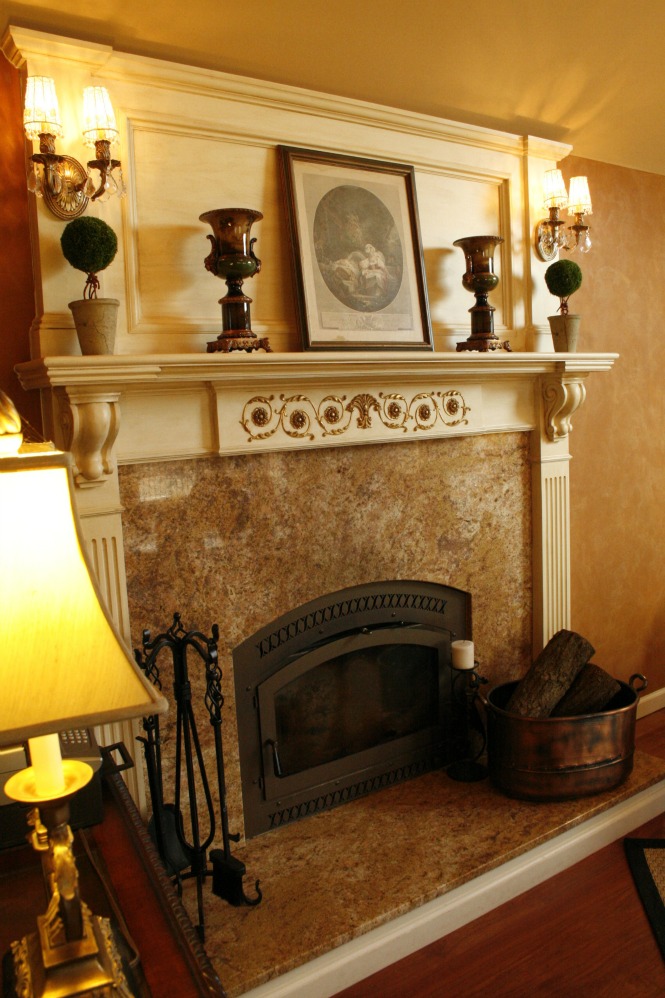 A simply decorated mantle in a great room. Gold leafing and antiquing a fireplace mantle