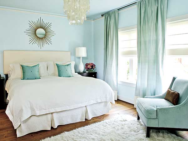 Sky blue bedroom with white bedding, starburst mirror and silk draperies