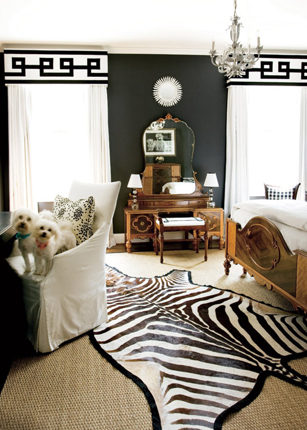 a contemporary bedroom using black  on the walls and white graphic draperies