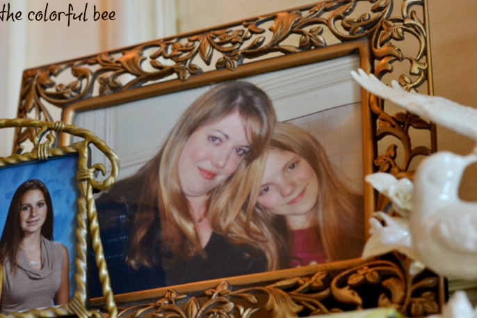 Pictures of mothers and daughters on a fireplace mantle