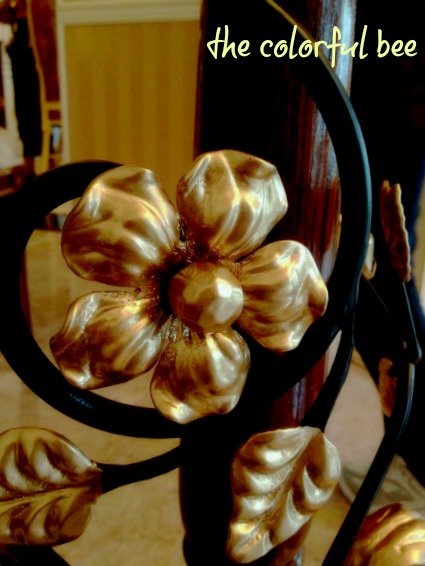 closeup of wrought iron flower with gold paint