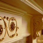 gilded and antiqued mantle and onlays on a fireplace mantle