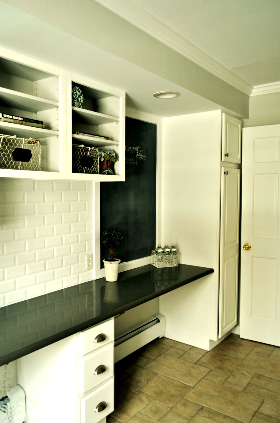 chalkboard in laundryroom with white cabinetry